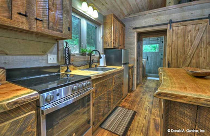 Picture of kitchen cabinets and sink of cabin house plan 1601 The Dwight as built by a customer