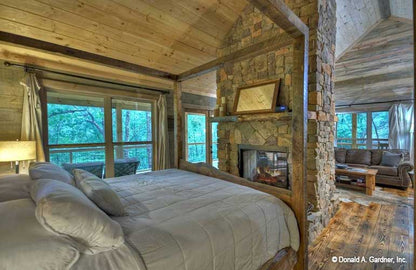 Picture in bedroom with fireplace of cabin house plan 1601 The Dwight as built by a customer