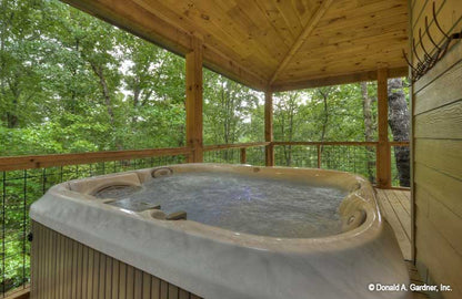 Picture of hot tub on porch of cabin house plan 1601 The Dwight as built by a customer