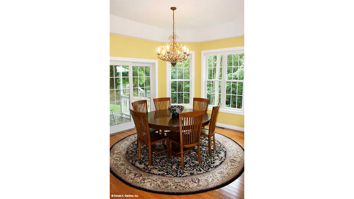 Wood floors and chandelier in the dining room. The Edelweiss plan 1013.