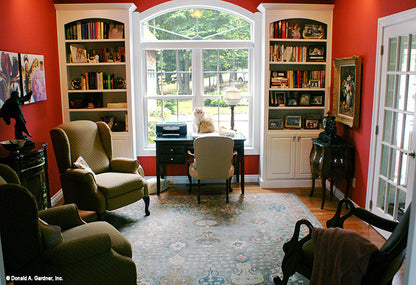 Arched window and built in bookcases in the study. The Edelweiss plan 1013.