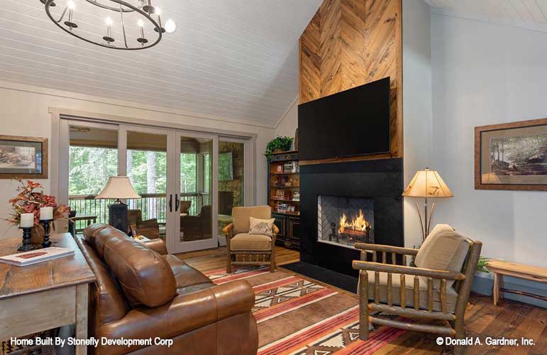 Herringbone pattern wood panels above the fireplace in the great room. The Eleanor plan 1314.