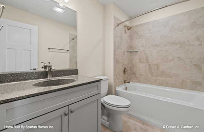 Single sink vanity and shower tub combination in the bathroom. The Ella plan 1344.