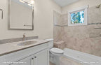 Single sink vanity and walk-in open shower in the bathroom. The Ella plan 1344.