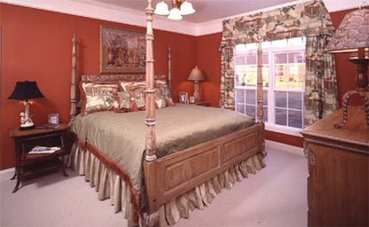 Carpet and orange walls in the master bedroom. The Emory plan 804.