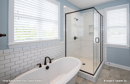 Master bathroom picture with tub and shower of one story house plan 1047 The Fieldstone