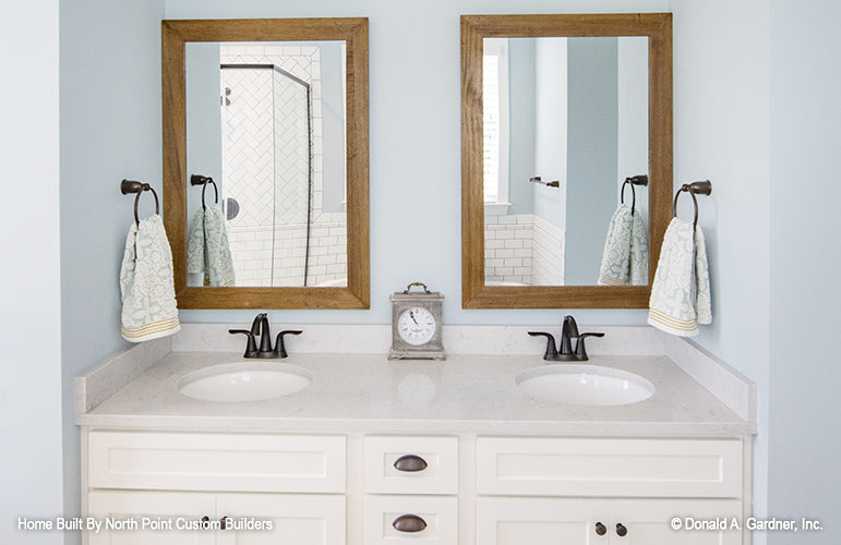 Double sink vanity in master bathroom of one story house plan 1047 The Fieldstone