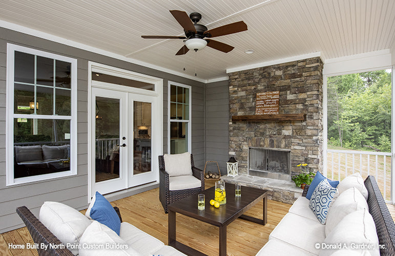 Picture of the screen porch and fireplace of Fieldstone house plan 1047