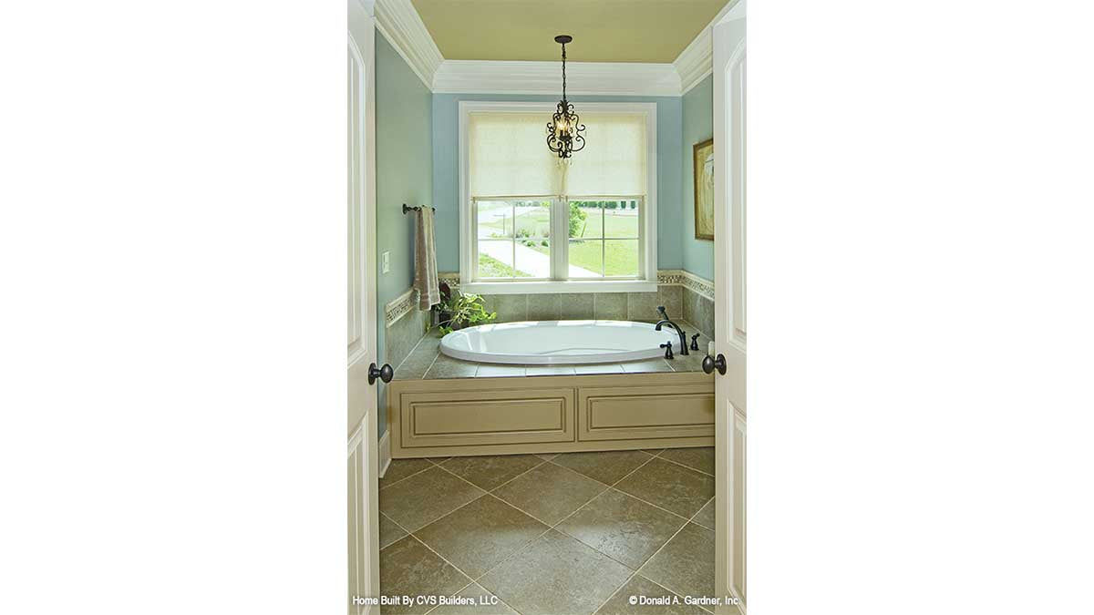 Soaking tub with a window behind it in the master bathroom. The Fincannon plan 1234.