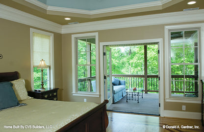 Open French doors to the patio from the master bedroom. The Fincannon plan 1234.