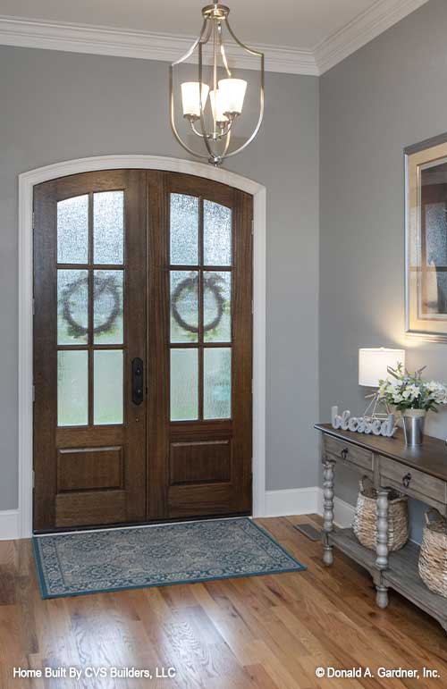 Arched double entry doors in the foyer. The Fletcher plan 1430.