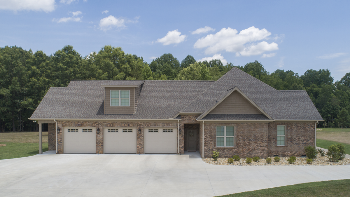 Side garage view photograph. The Fletcher plan 1430.