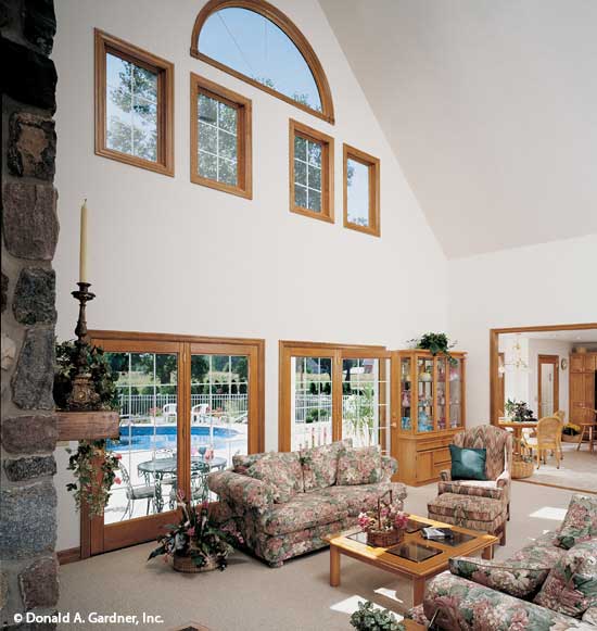 This is a great room picture with rear view windows of house plan 306 The Forrester