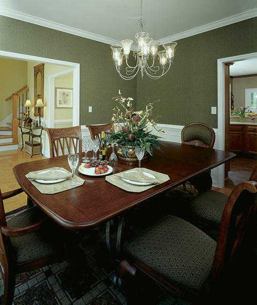 Crown molding along ceiling and chandelier in the dining room. The Gasden plan 431.