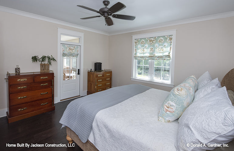 Flat ceilings with crown molding and a door to the patio in the master bedroom. The Glousester plan 1188. 