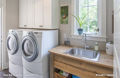 Mud room sink and washer and dryer in the utility room. The Glousester plan 1188. 