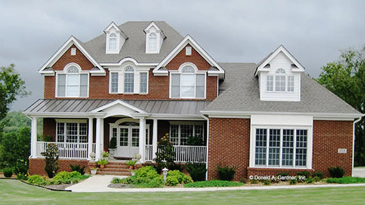 Stately and sophisticated brick Traditional home with a wide welcoming porch