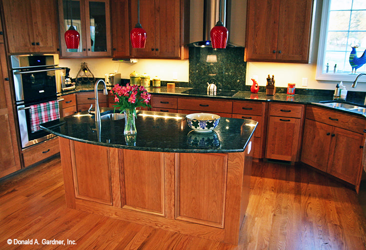 Island with a sink in the kitchen. The Hammond Hill plan 1217.