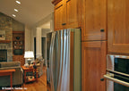 Brown cabinets in the kitchen. The Hammond Hill plan 1217.