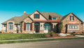 This is a photograph of the front of Luxury Craftsman house plan 1375 The Harrison as built by a customer