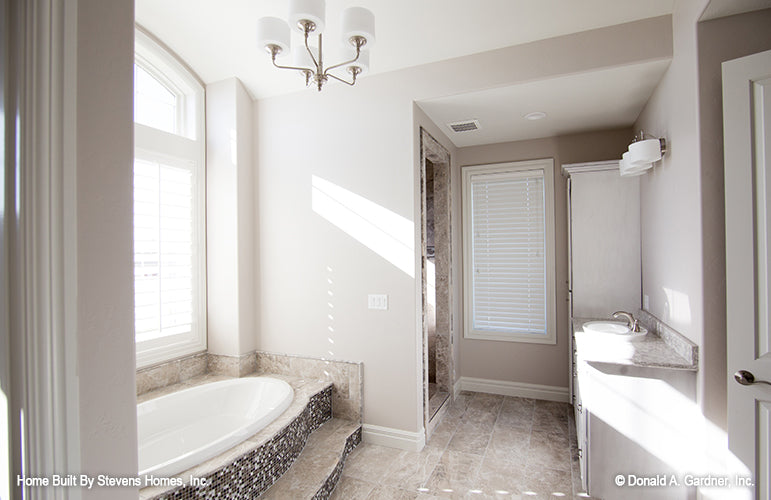 The master bath provides a private oasis for one story house plan 1375 The Harrison