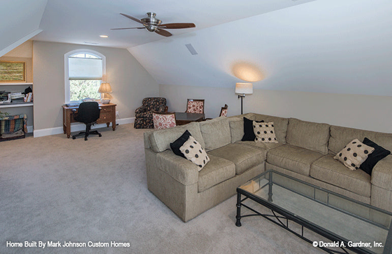 Clipped ceilings and ceiling fan in the bonus room. The Hartwell plan 1221.