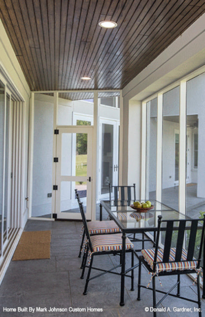 Recessed lighting and stained wood panels on the ceiling in the screened in porch. The Hartwell plan 1221.