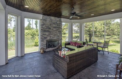 Outdoor fireplace in the sunroom. The Hartwell plan 1221.