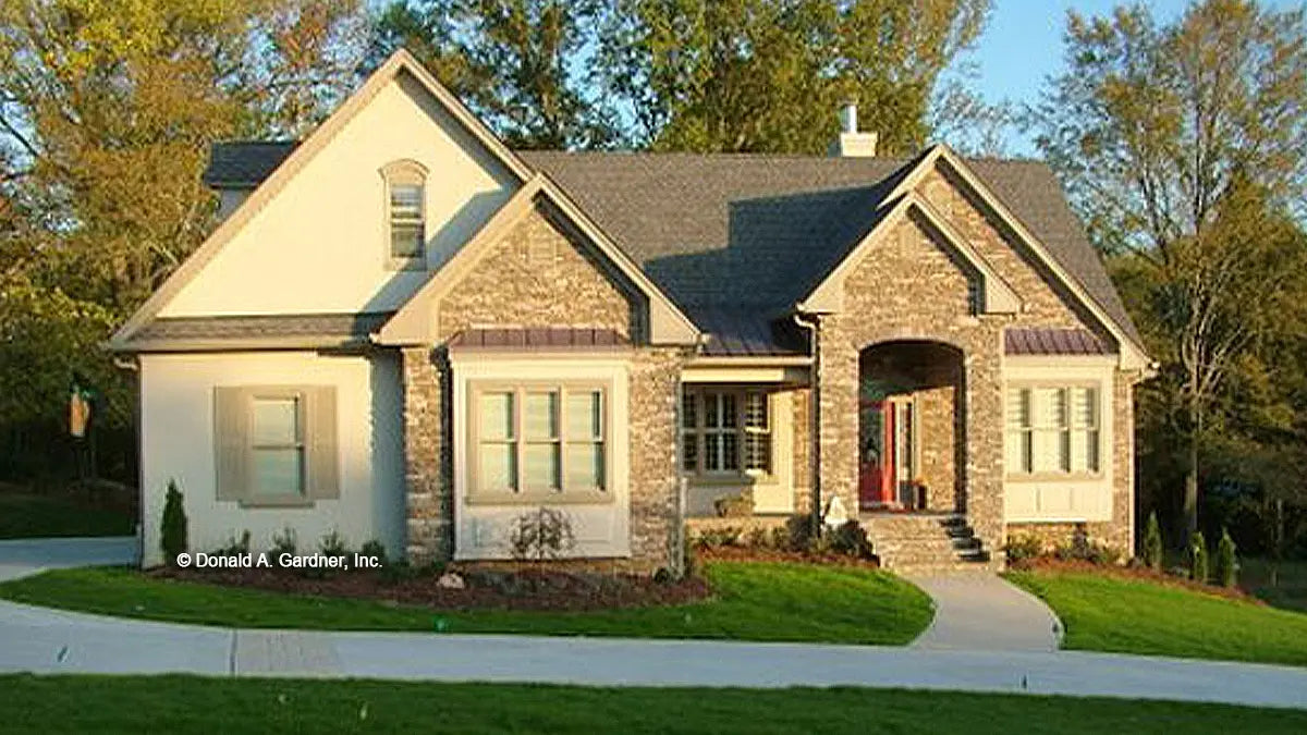 Craftsman exterior produces ultimate curb appeal with a stone and cedar shake facade. 