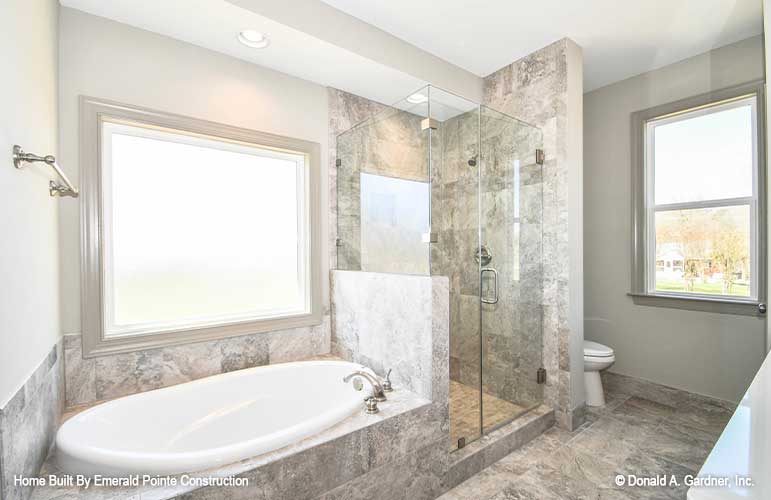 Tiled walk-in shower between the sitting tub and toilet in the bathroom. The Hazelwood plan 884. 