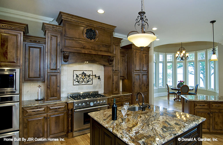 Island in the center of the kitchen with a sink. The Heatherstone plan 5016. 