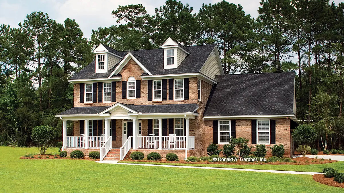 This is a photograph submitted by the customer. Front view two story brick home. The Heywood plan 991.