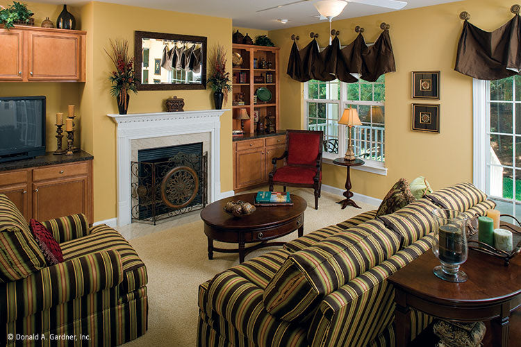 Fireplace with built in bookcases on either side in the great room. The Heywood plan 991.