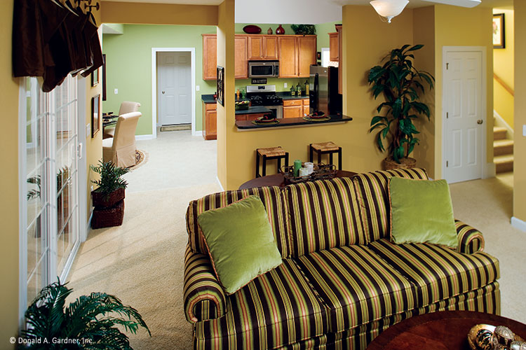 Great room view into the kitchen from the bar. The Heywood plan 991.