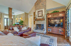 Rustic great room with two story ceiling and fireplace for High-Pointe house plan 713