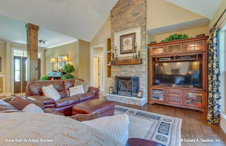 Rustic great room with two story ceiling and fireplace for High-Pointe house plan 713