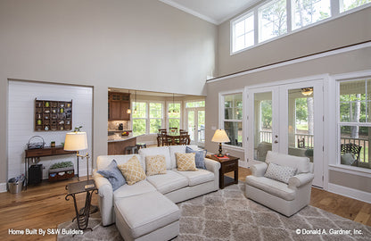 Open great room with double doors leading to the porch. The Hinnman plan 1242. 