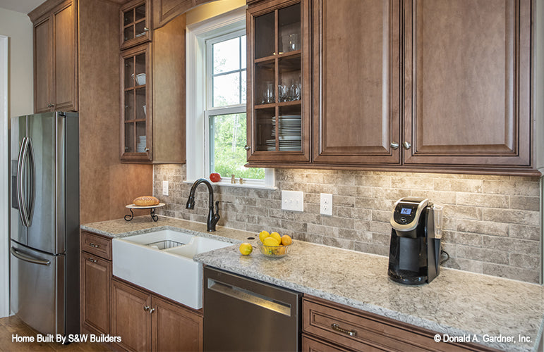 Kitchen view of the farmhouse style sink with window above. The Hinnman plan 1242. 