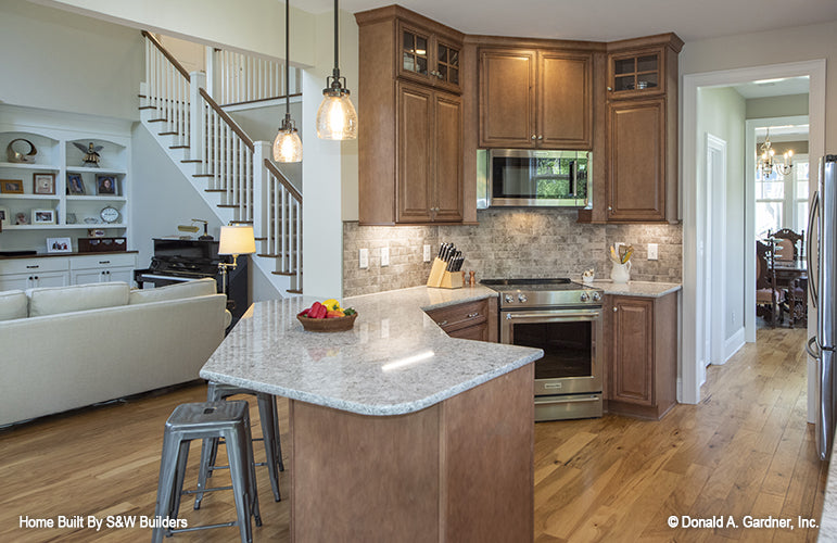 Counter height bar seating in the kitchen. The Hinnman plan 1242. 