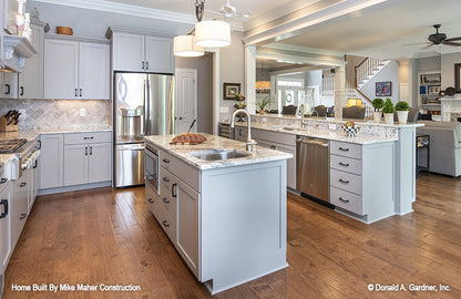 Island in the center of the kitchen with a sink. The Holden plan 1168.