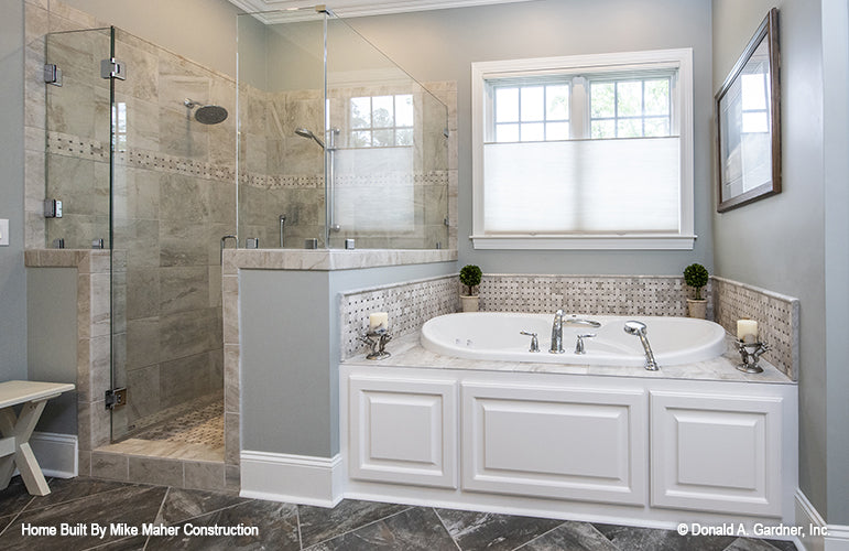 Soaking tub next to the walk-in shower in the master bathroom. The Holden plan 1168.