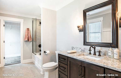 Single sink vanity and tub shower combo in the bathroom. The Hollowcrest plan 5019.