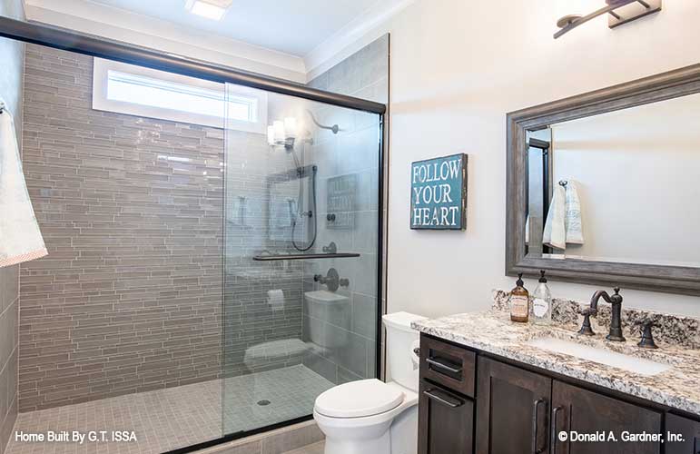 Walk-in shower with small window in the bathroom. The Hollowcrest plan 5019.