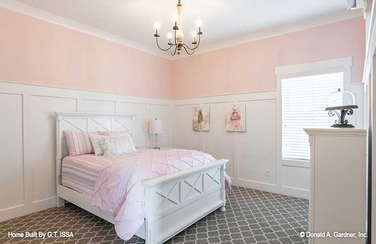 Secondary bedroom with crown molding ceiling. The Hollowcrest plan 5019.