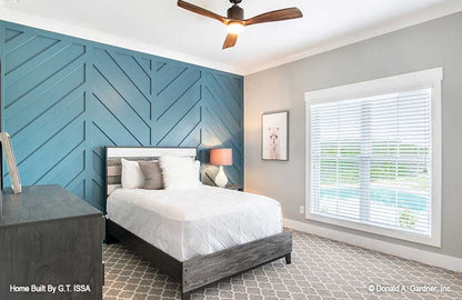 Secondary bedroom with textured accent wall. The Hollowcrest plan 5019.