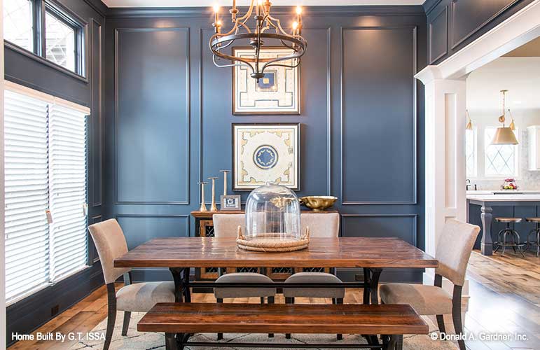 Navy blue walls in the dining room. The Hollowcrest plan 5019.