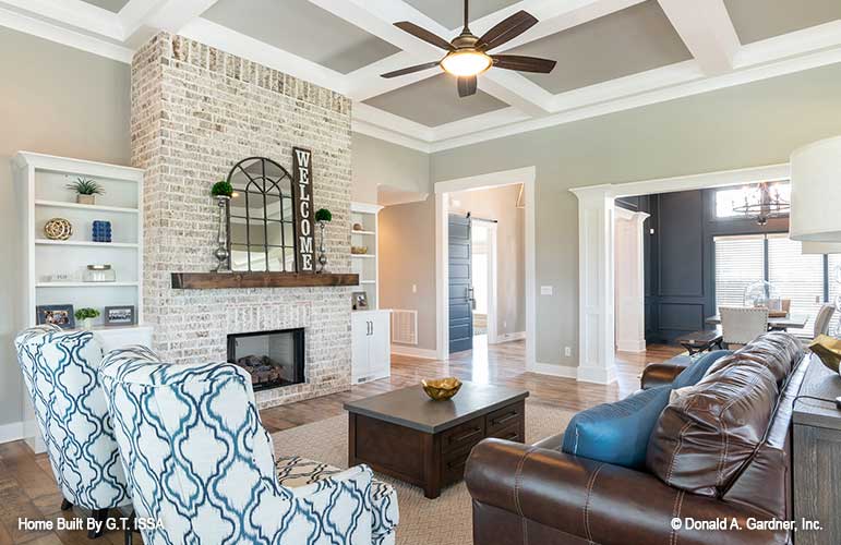 Coffered ceiling and brick fireplace in the great room. The Hollowcrest plan 5019.