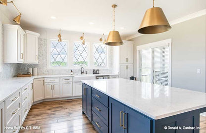 White cabinets in the kitchen. The Hollowcrest plan 5019.