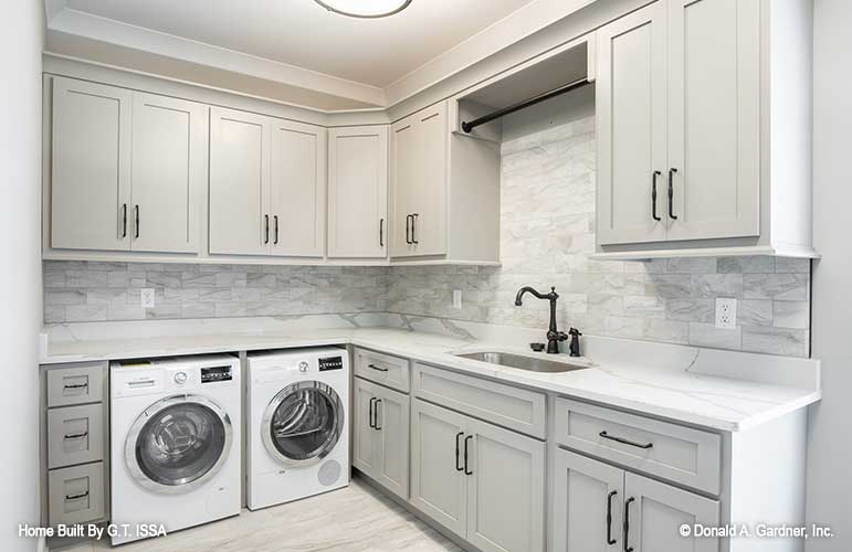 Cabinets and sink in the utility room. The Hollowcrest plan 5019.