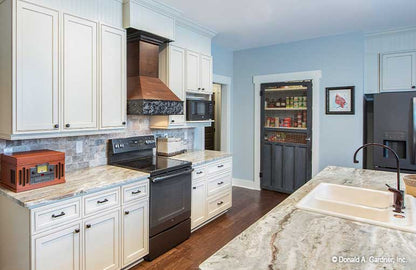 White cabinets in the kitchen. The Hunter Creek plan 1326.